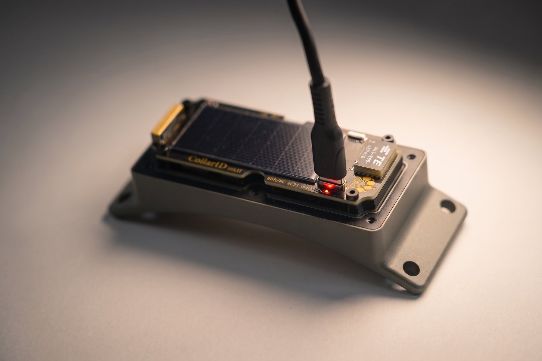 Close-up of the charge LED area showing the red LED illuminated