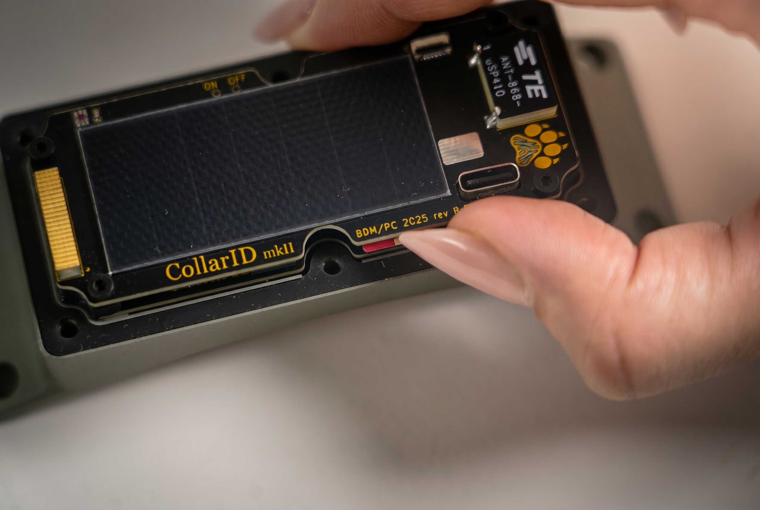 A finger pushing the SD card further into the slot to trigger the spring release